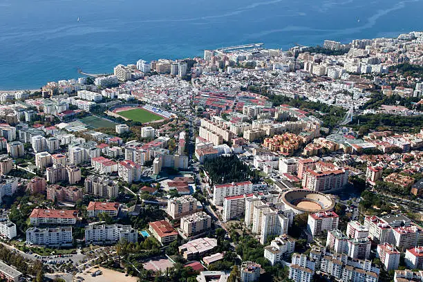 Aerial view of Marbella with its soccer field and bull ring, Spain.