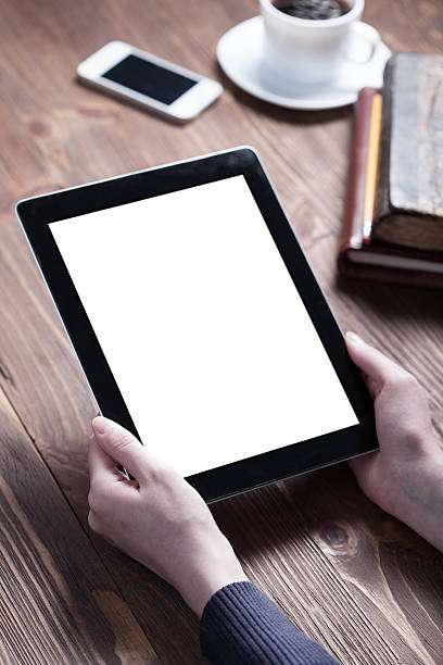 istock Woman using digital tablet with smartphone, coffee and books 468145134