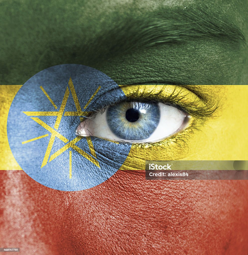 Human face painted with flag of Ethiopia Fan - Enthusiast Stock Photo