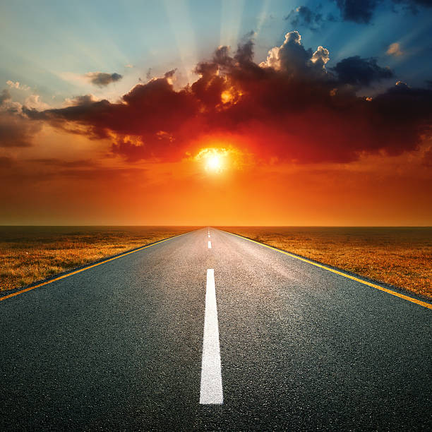 istock Driving on an empty road against the setting sun 468154447