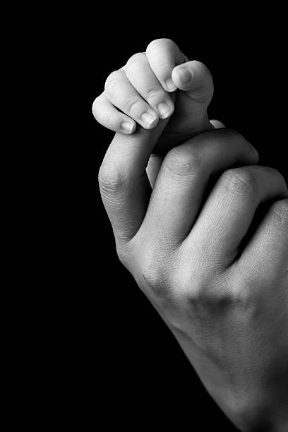 istock Baby's hand clutching the parent's finger 468155801