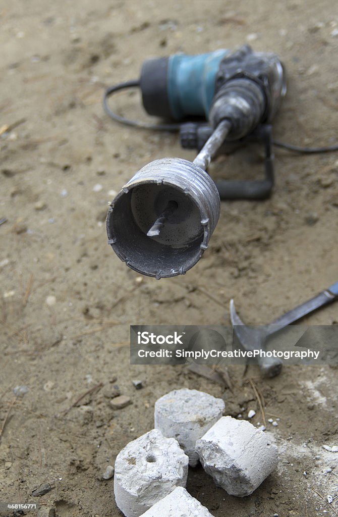 Core Drilling Bit with Concrete Slug A core drilling bit with a concrete slug still inside it. Cement Stock Photo