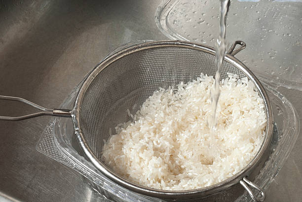 istock Washing with fresh water white rice in the sink 468156917