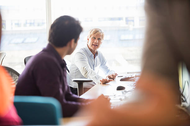istock Serious businessman discussing with colleague in office 468157974