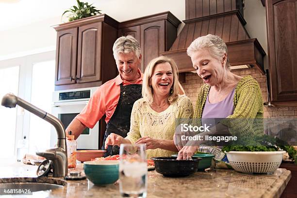 Senior People Having Fun In The Kitchen Stock Photo - Download Image Now - 2015, 50-59 Years, 60-69 Years