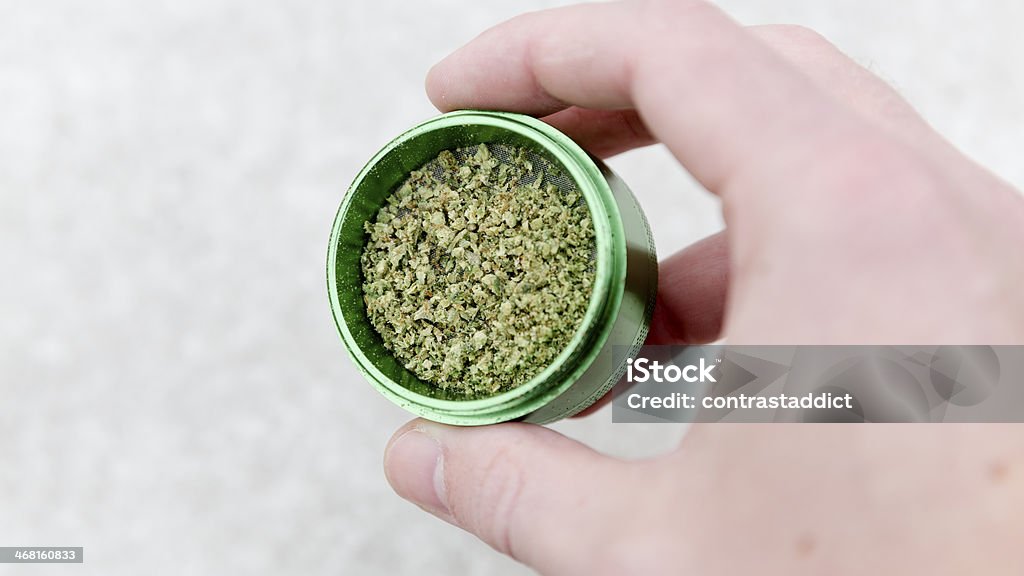 Marijuana in grinder. Marijuana nugs in a grinder about to be ground up. Alternative Medicine Stock Photo