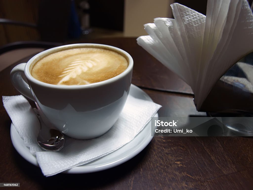 Cappucino cup White cappucino cup with spoon on dark wood table 2015 Stock Photo