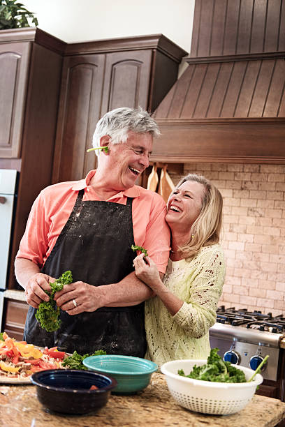istock Senior people having fun in the kitchen 468161580