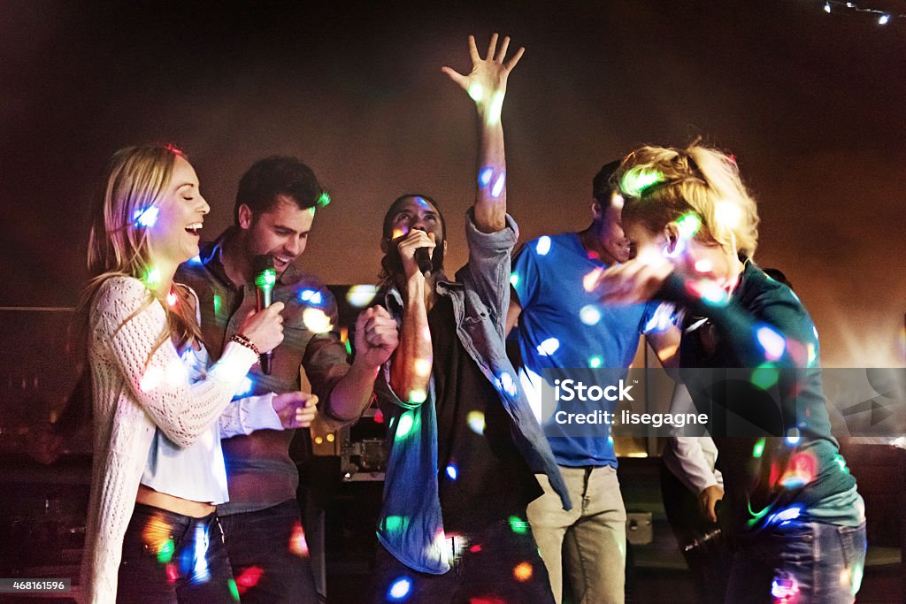 Group of friends doing karaoke Karaoke Stock Photo