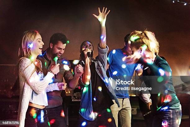 Group Of Friends Doing Karaoke Stock Photo - Download Image Now - Karaoke, Singing, Party - Social Event
