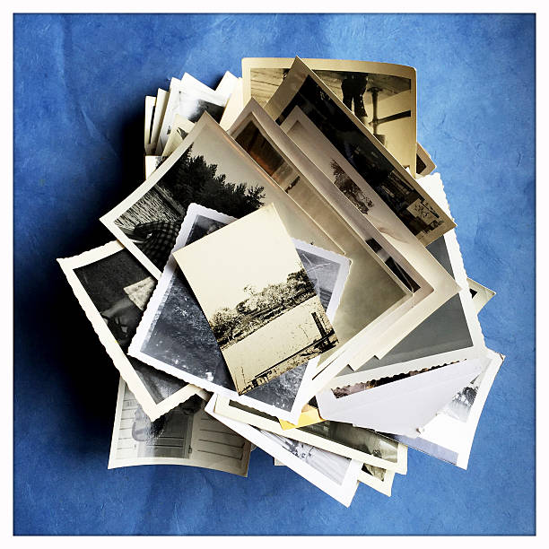 istock Old Photographs in a Pile on Blue Background 468162002