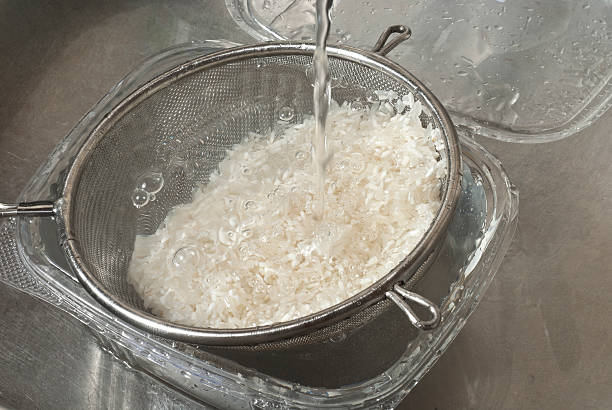 istock Washing with fresh water white rice in the sink 468162365