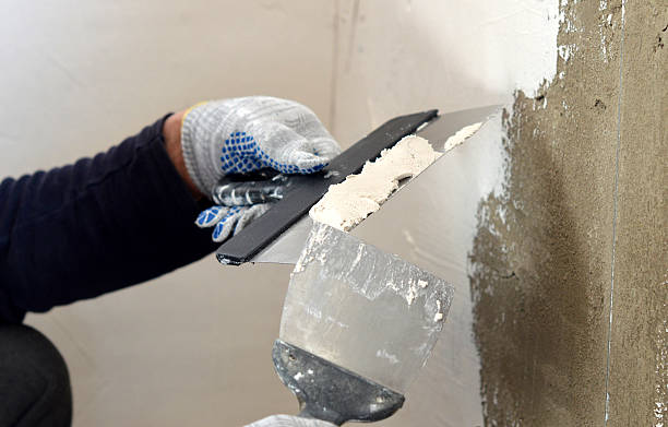 istock The process of the concrete wall putty two spatulas 468162376