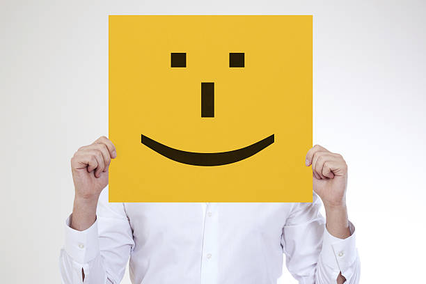 istock Businessman holding smile placard 468163315