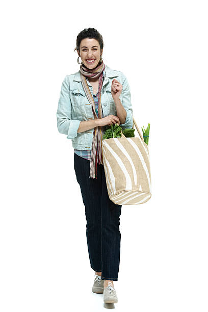 istock Cheerful woman walking with vegetable bag 468163721