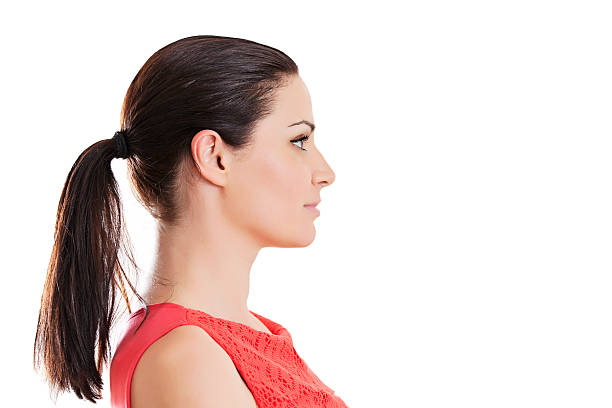 Profile portrait of a young woman Profile portrait of a young woman ponytail stock pictures, royalty-free photos & images