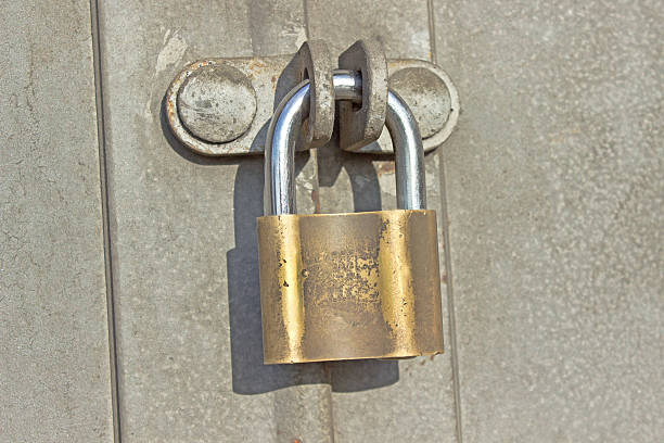 istock Padlock on old metal door 468164379