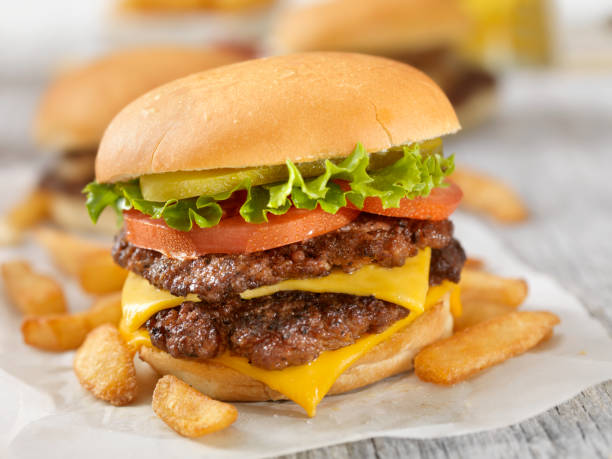 Traditional Homestyle Burger A Double cheeseburger with all the fixings - Photographed on Hasselblad H3D2-39mb Camera dill pickle stock pictures, royalty-free photos & images
