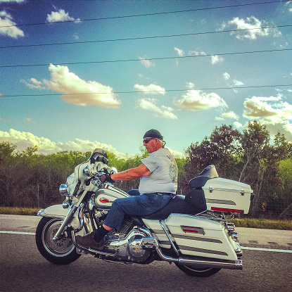 Everglades Parkway, Florida, USA  - January 21, 2015: Motorcyclist moving on a highway, Florida, USA