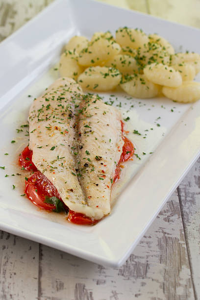 istock Fish fillet on tomato bed with gnocchi 468171443