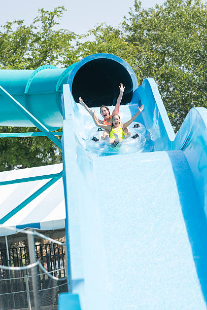 istock Mother and daughter on giant water slide 468172464
