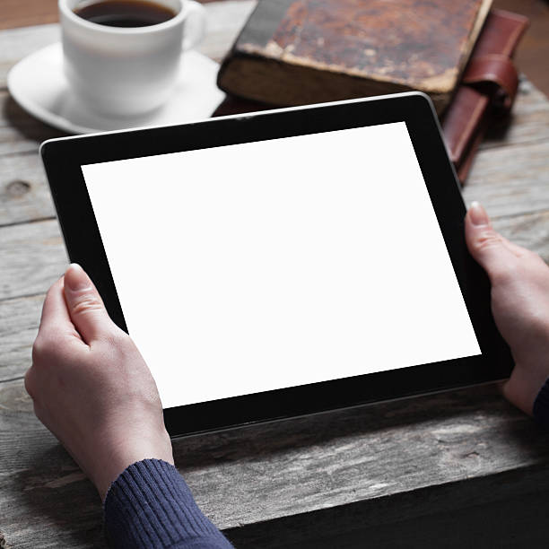 istock A woman holding a digital tablet on a table with coffee  468172634