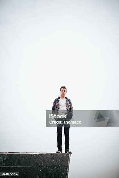Young Man Standing On Stone Block Stock Photo - Download Image Now - 20-24 Years, 20-29 Years, 2015