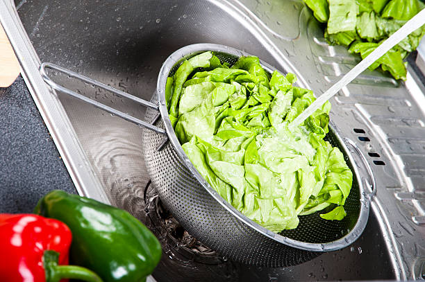 istock Fresh salad splashing in water before cooking 468176159