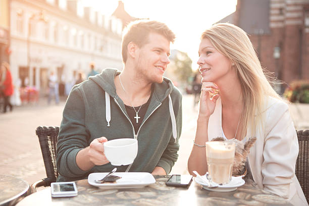 A young couple having conversation at a Cafe in Paris, France. 