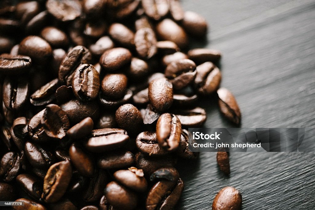 Coffee Beans Photograph of scattered roasted coffee beans. Close-up Stock Photo