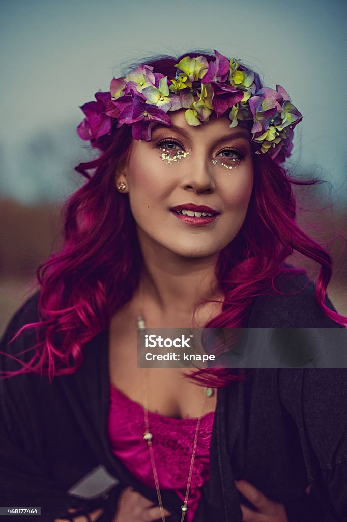 Beautiful woman with pink hair and flower garland Beautiful woman with long pink hair and glitter make up and flower garland 18-19 Years Stock Photo