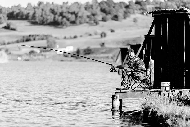 man fishing and relaxing. summer shoot, black and white colors.