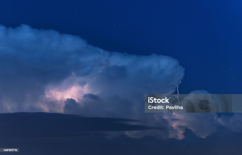 Thunderstorm Cloudscape Lightning discharge in a cloud Discharge of lightning in a stormy cloud during night time. 2015 Stock Photo