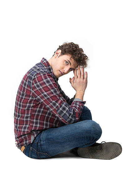 istock young man sitting on the floor 468183514