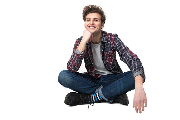 istock Smiling young man sitting on the floor 468183516