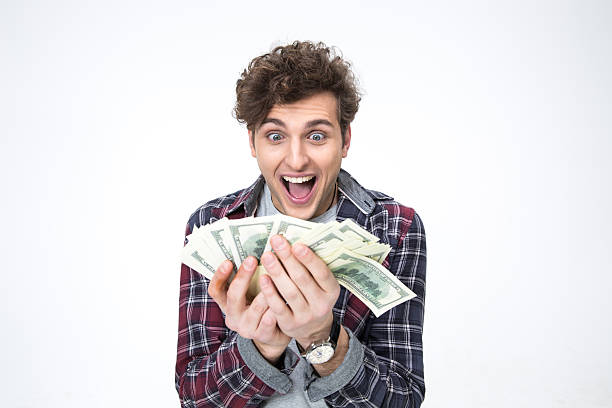 istock young man holding bills of dollars 468183544