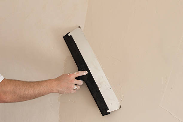 istock process of applying a wide spatula second layer of putty 468183860