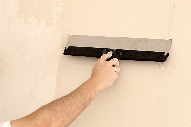 istock process of applying a wide spatula second layer of putty 468183886