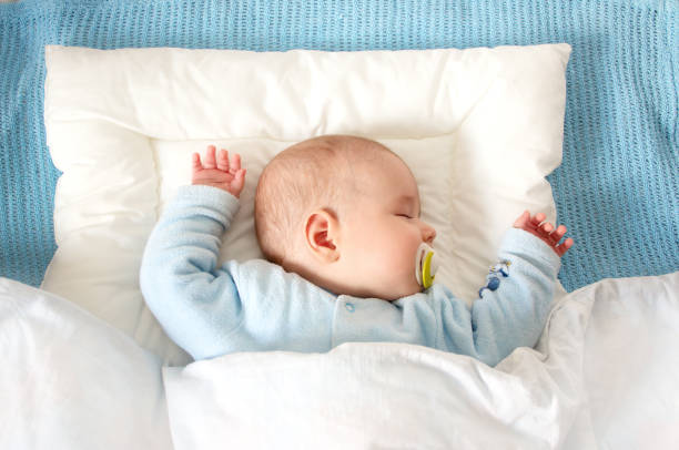 istock Four month old baby sleeping on blue blanket 468187862