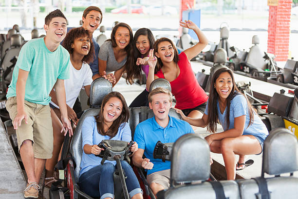 istock Group of teens at amusement park on go-carts 468190952