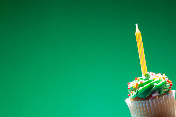 Birthday cupcake on green background Macro shot of birthday cupcake birthday cake green stock pictures, royalty-free photos & images