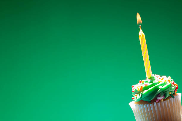 istock Birthday cupcake on green background 468193546