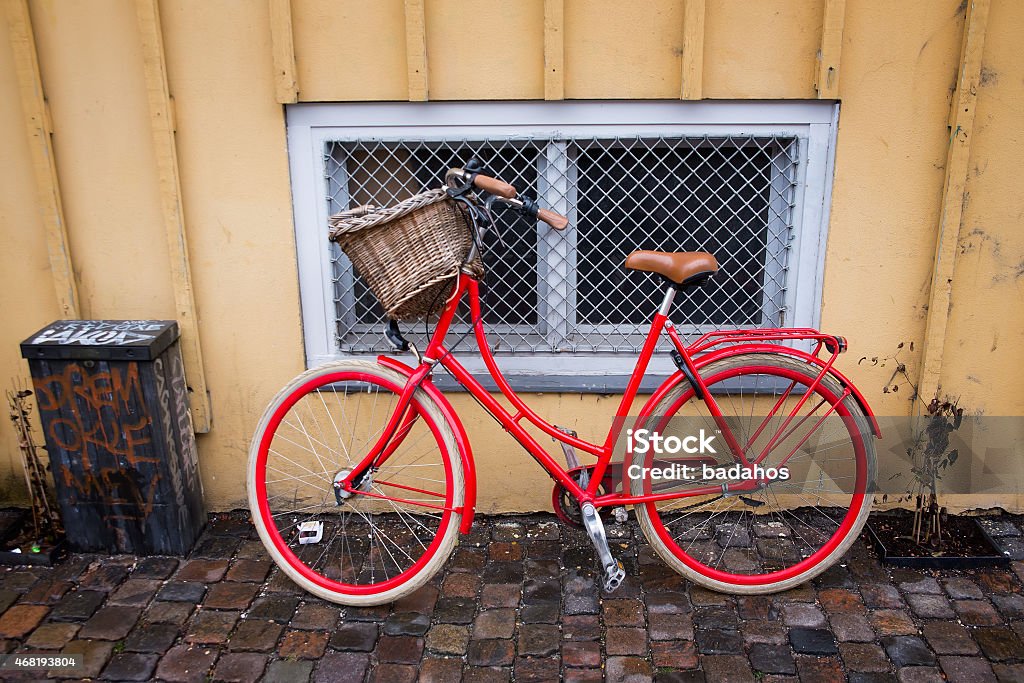 red bike red bike near yellow wall 2015 Stock Photo