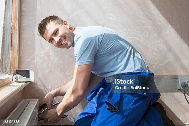 Smiley Handyman At Work Stock Photo - Download Image Now - Plumber, Radiator - Heater, Portrait