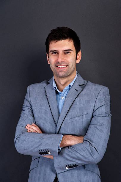 istock Cool businessman standing on grey background 468196075