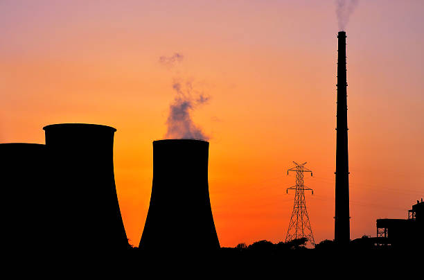 istock Power plant and high voltage tower at sunrise 468200702