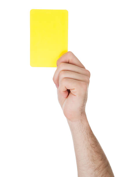 Hand Showing Yellow Card Closeup Of Male Soccer Referee Hand Holding Yellow Card judge sports official stock pictures, royalty-free photos & images