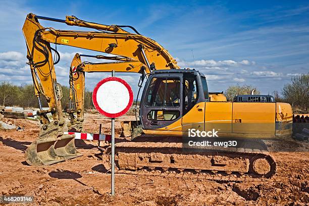 Yellow Excavators In A New Road Construction Stock Photo - Download Image Now - 2015, Backhoe, Bulldozer