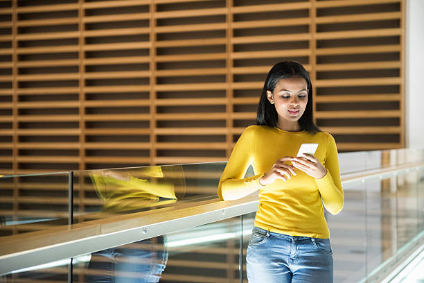 istock Beautiful businesswoman using mobile phone outside office 468207822
