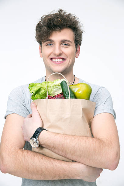 istock man with bag full of groceries 468208258